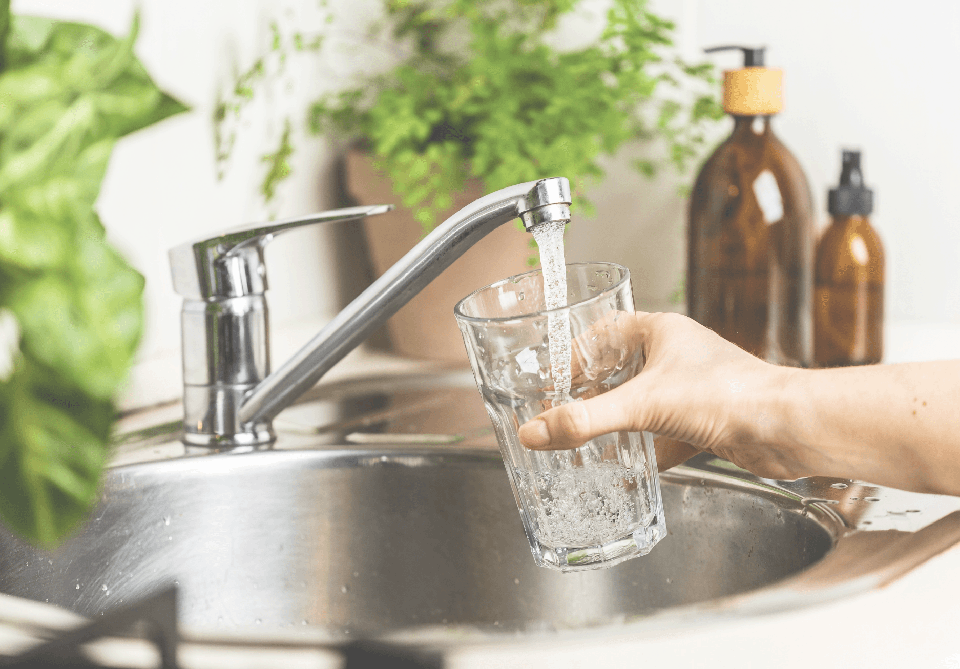 Cheerful girl drinks fresh water